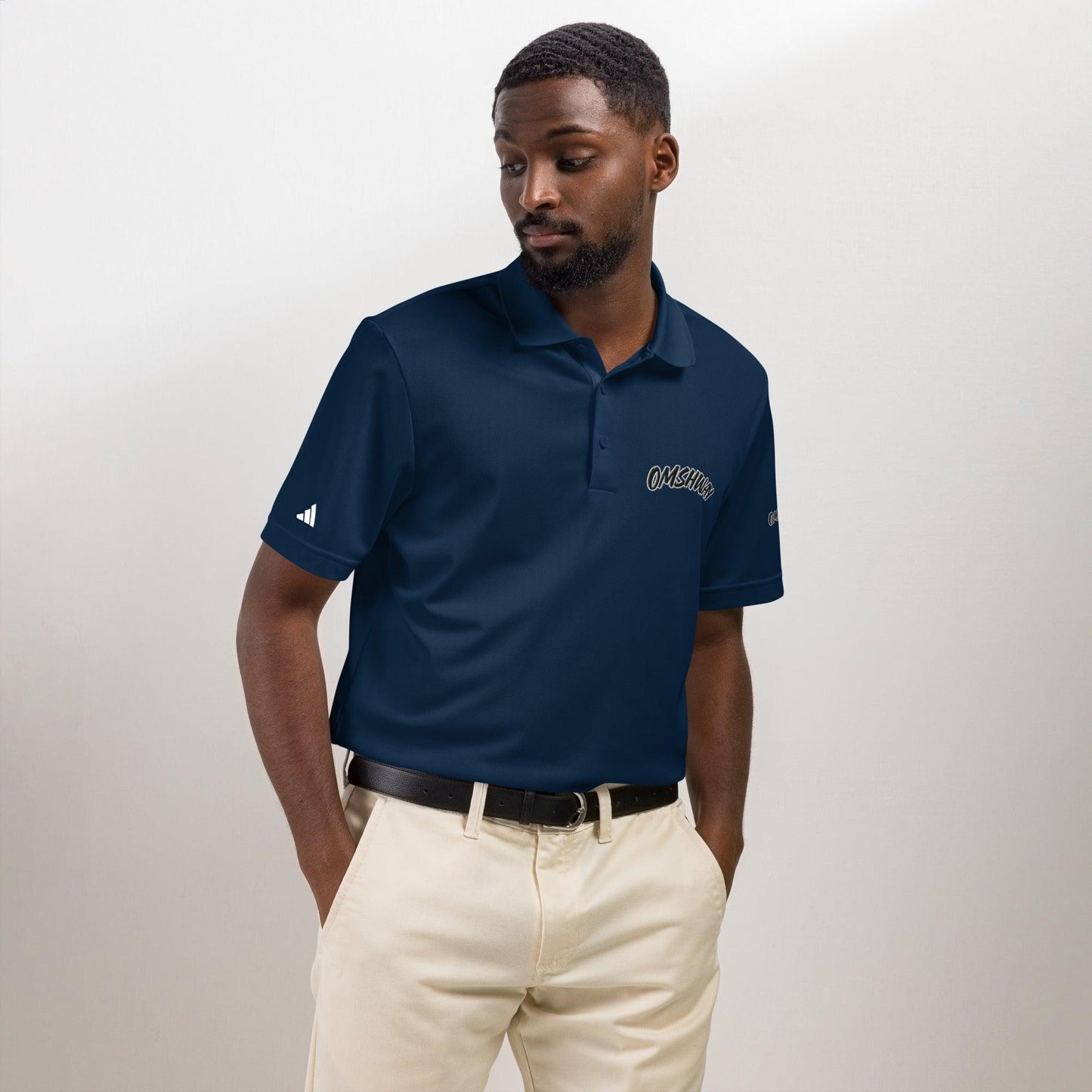 Omshway x Adidas Sport Polo featuring a sleek, athletic design with a comfortable fit, blending style and performance. Perfect for casual and active wear, with the iconic Adidas logo navy front