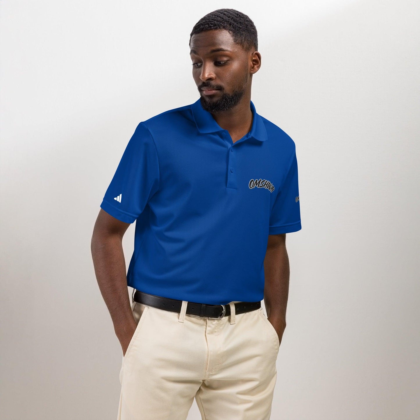 Omshway x Adidas Sport Polo featuring a sleek, athletic design with a comfortable fit, blending style and performance. Perfect for casual and active wear, with the iconic Adidas logo royal blue front