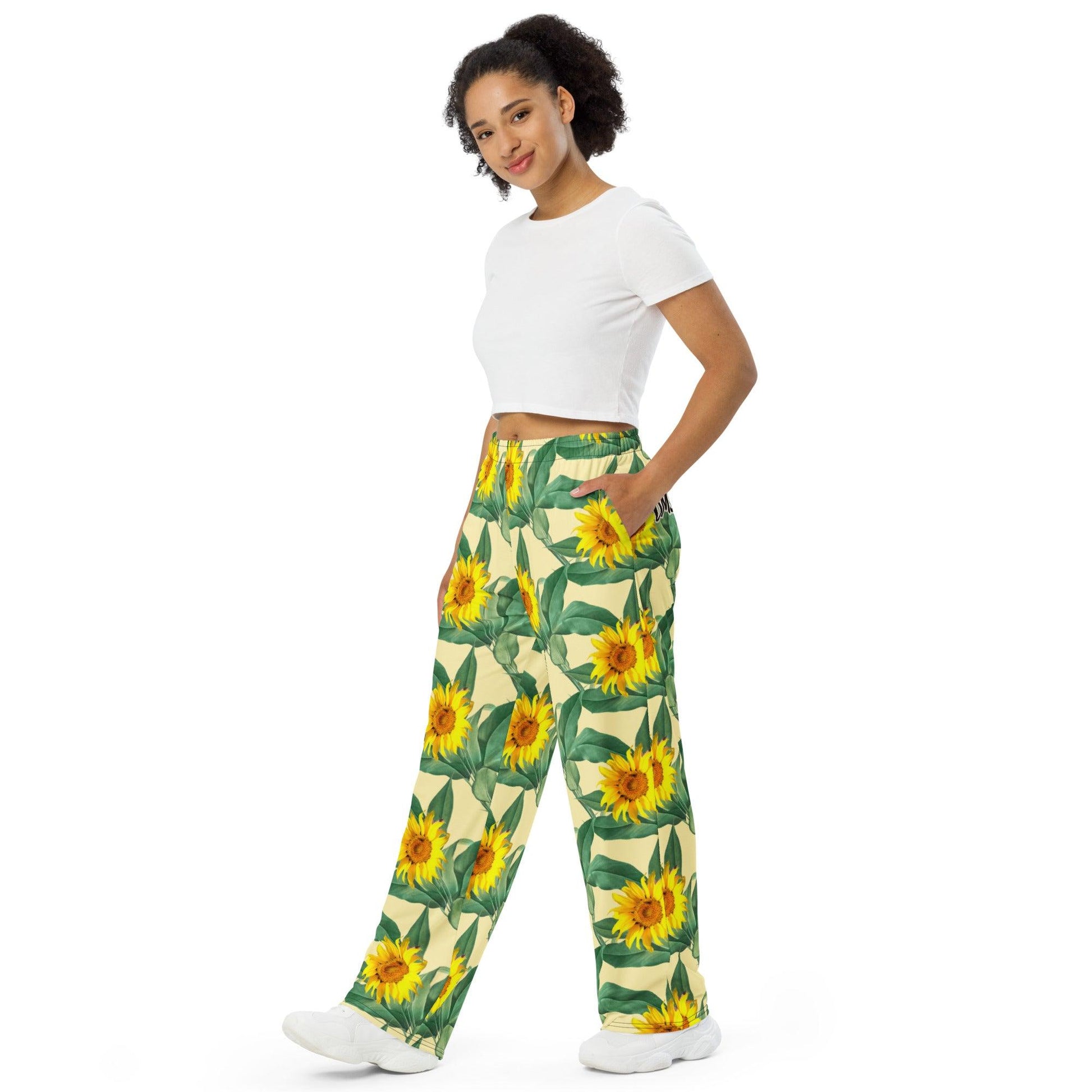 Unisex wide-leg pants featuring an all-over rose flower print, perfect for casual or boho-inspired outfits. Comfortable and stylish design for both men and women left front view- Omshway Store