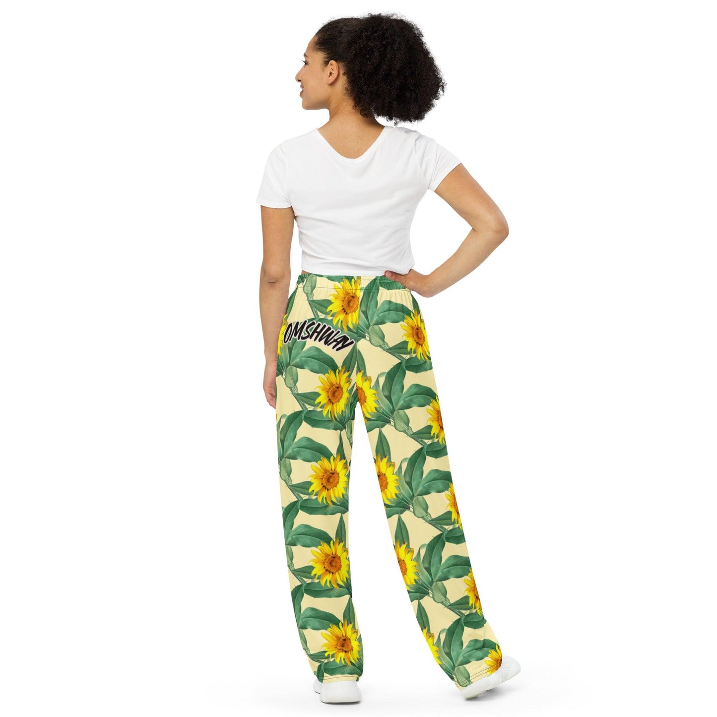 Unisex wide-leg pants featuring an all-over rose flower print, perfect for casual or boho-inspired outfits. Comfortable and stylish design for both men and women back view- Omshway Store