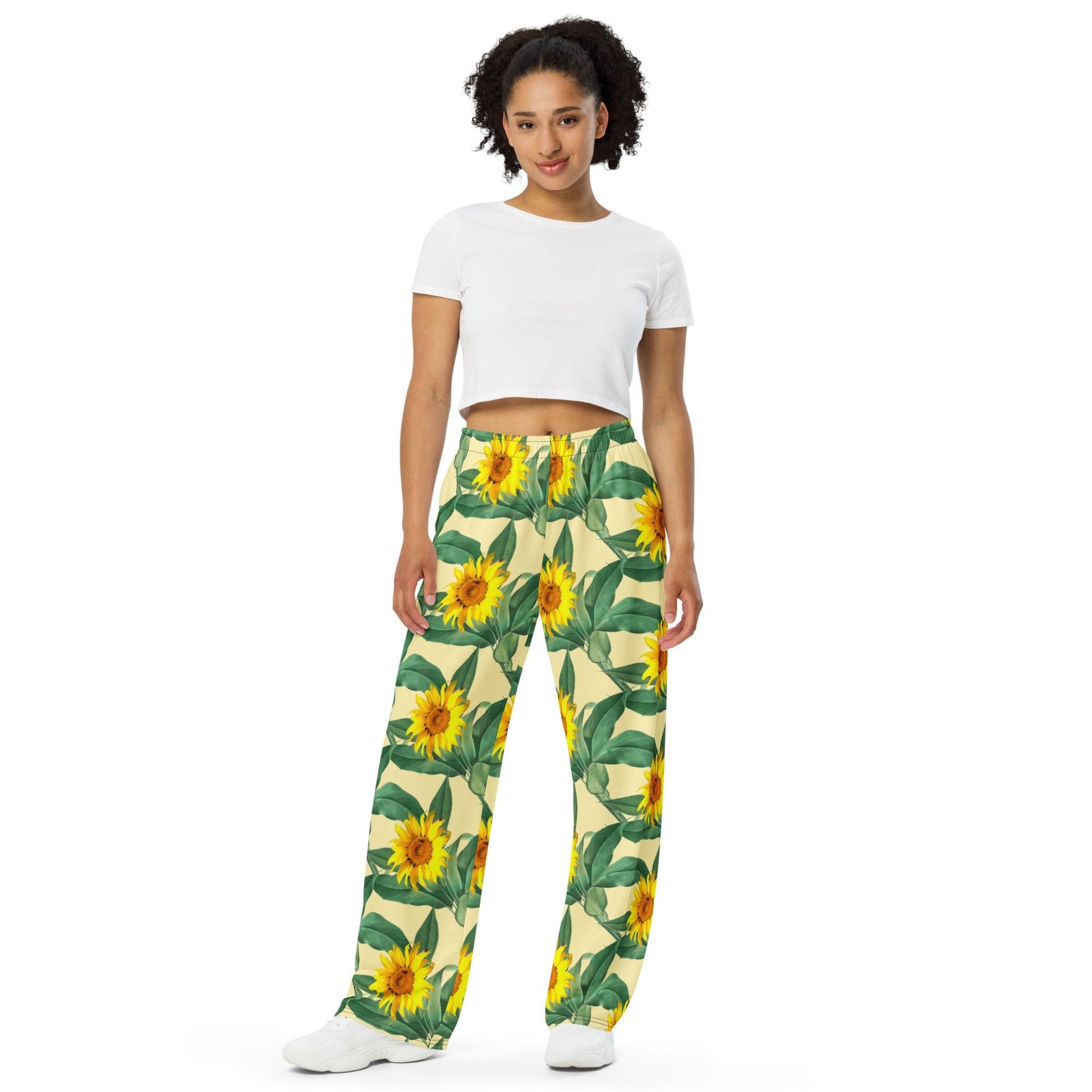 Unisex wide-leg pants featuring an all-over rose flower print, perfect for casual or boho-inspired outfits. Comfortable and stylish design for both men and women front view - Omshway Store